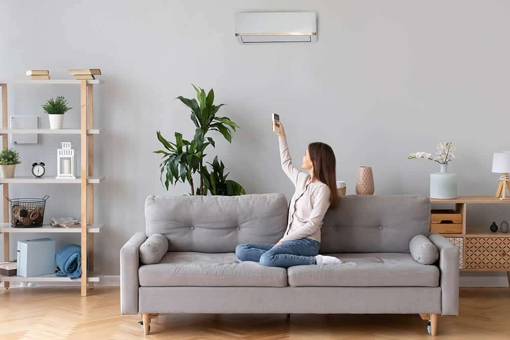 Person’s hand switching on an AC