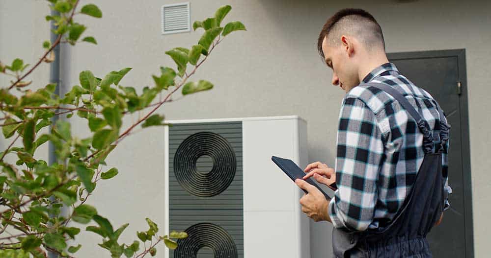A technician from Plan B A/C inspecting or installing a heating unit.