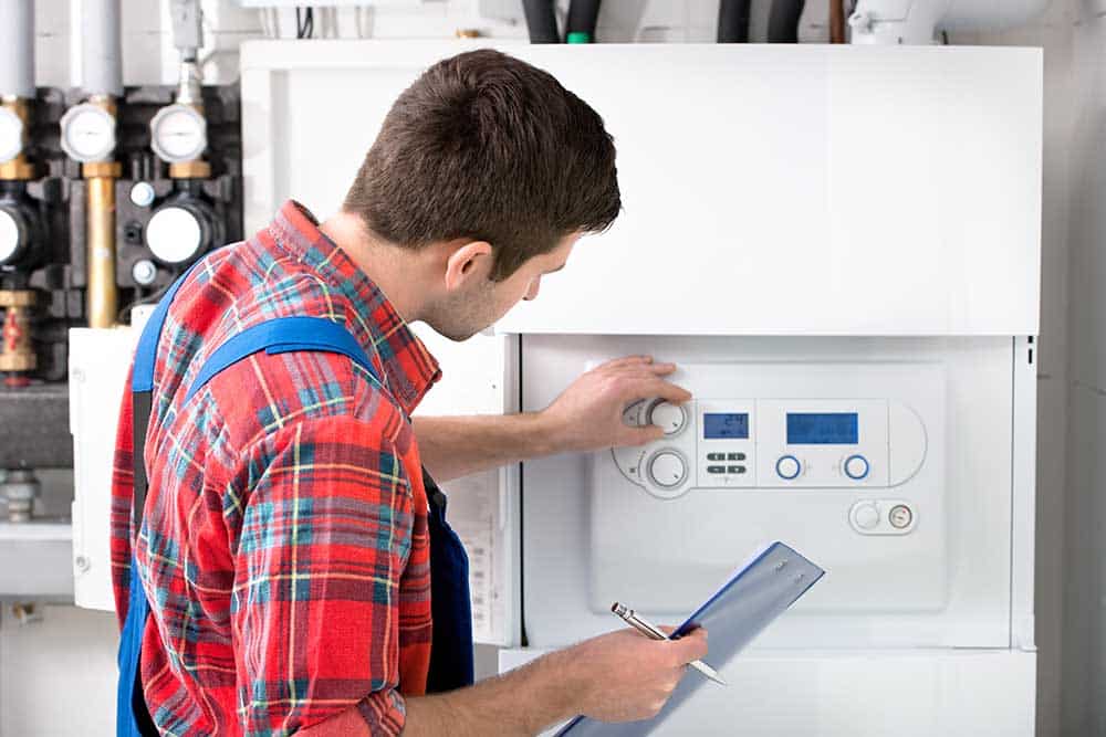 A technician showcasing a high-efficiency heating system.