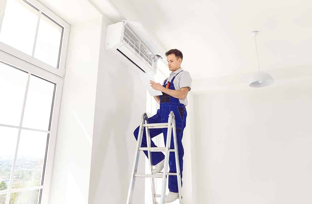 A technician installing a central AC unit in a modern home, showcasing expertise and attention to detail.