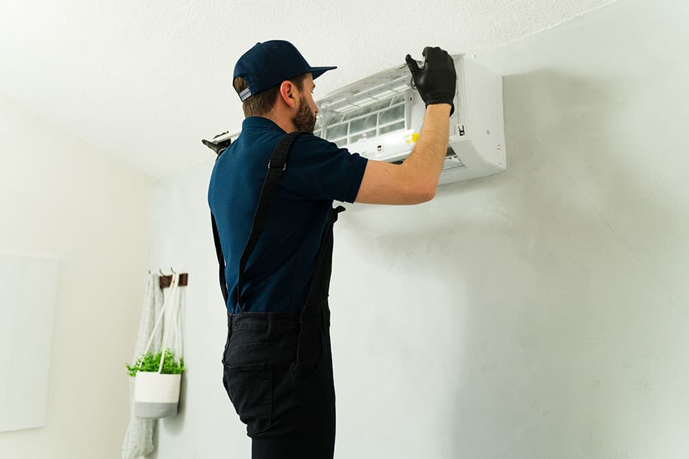 A sleek, modern central AC unit being installed by a professional technician.