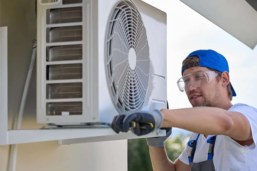 A technician performing maintenance on a modern HVAC system, with a focus on professionalism and quality tools.
