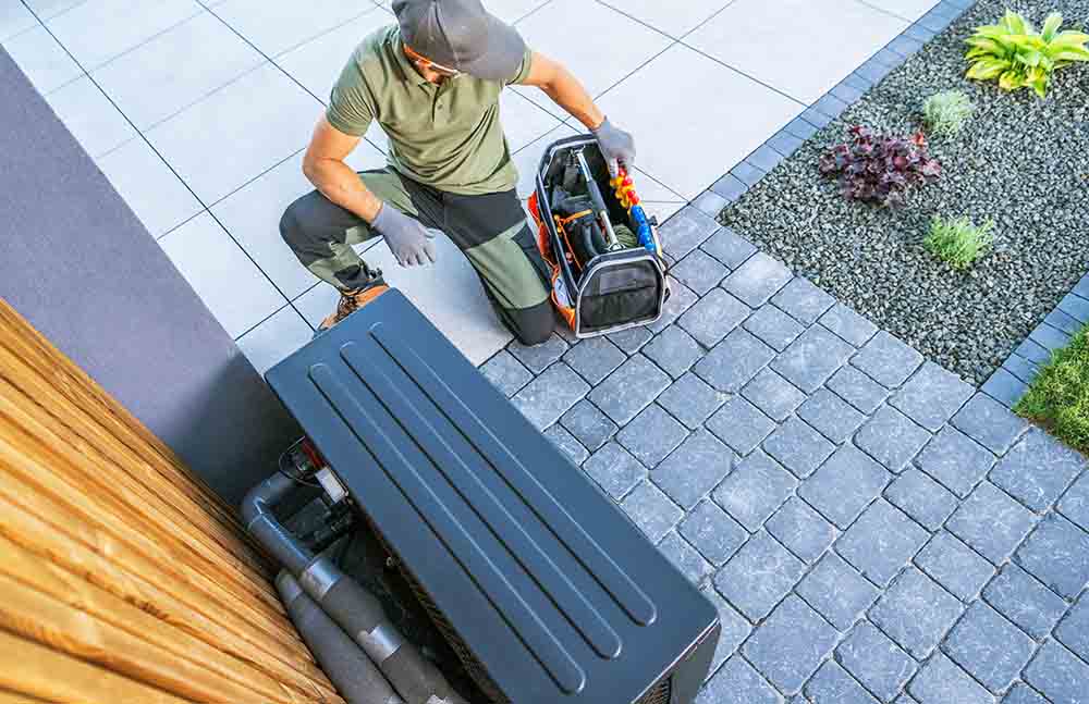 Technician vacuuming air ducts with protective gear on