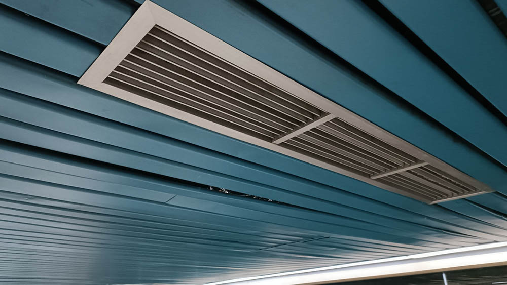Technician cleaning residential air ducts
