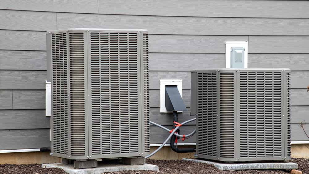 A technician installing a heat pump system.