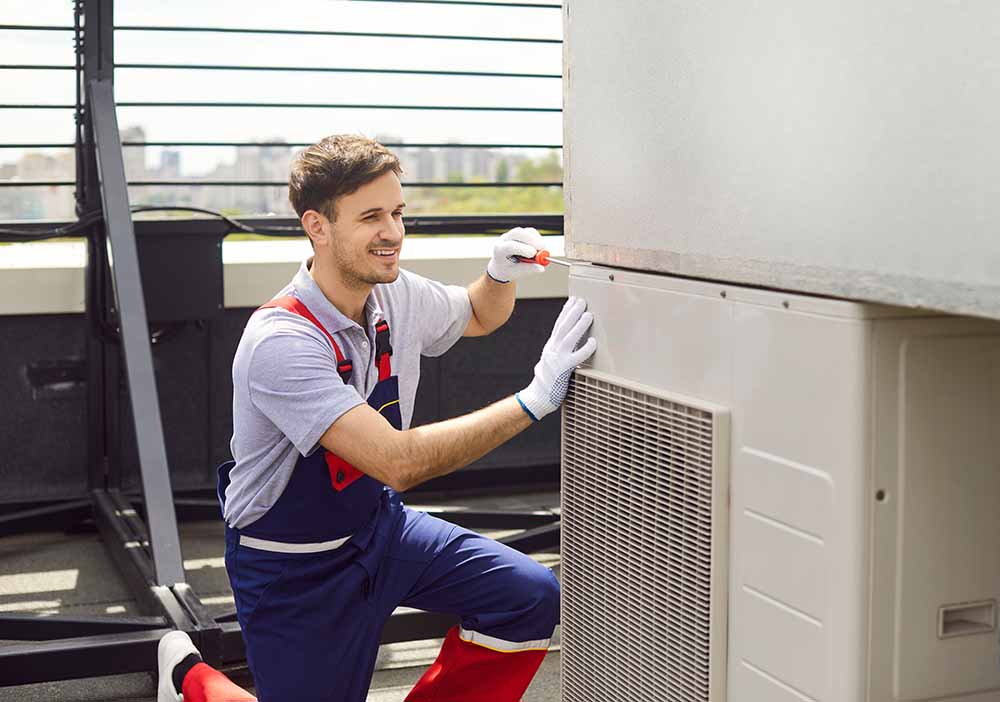 A technician conducting seasonal heater maintenance.