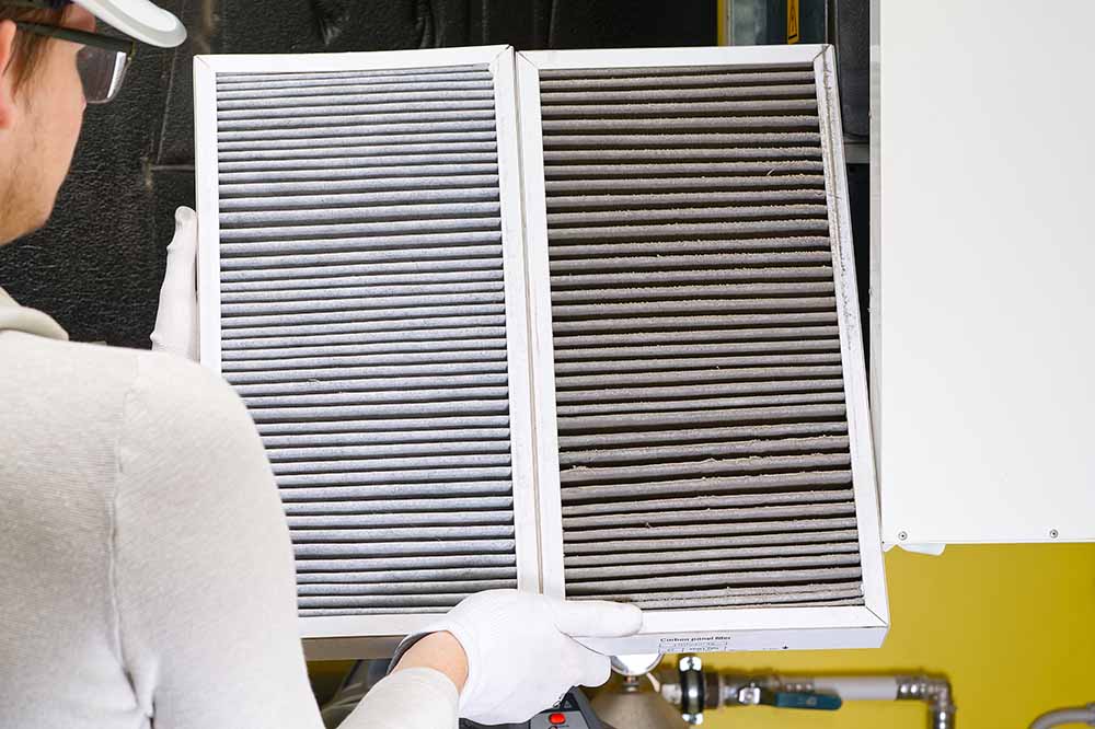 A technician checking furnace airflow.