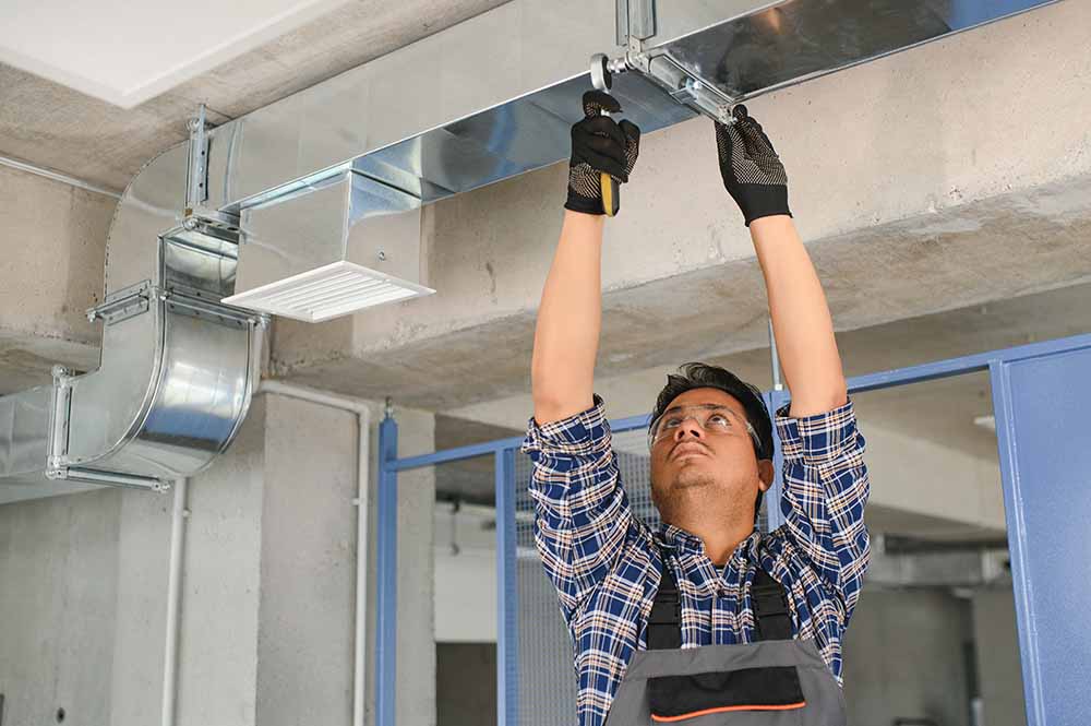 A technician inspecting home air ducts.