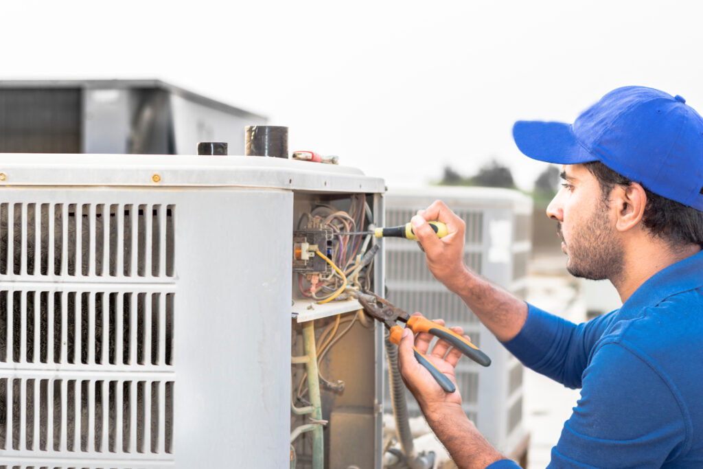 technician installing a central air conditioner