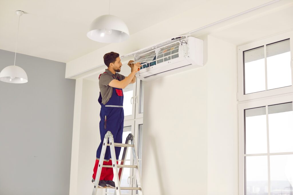 technician inspecting home air conditioning unit