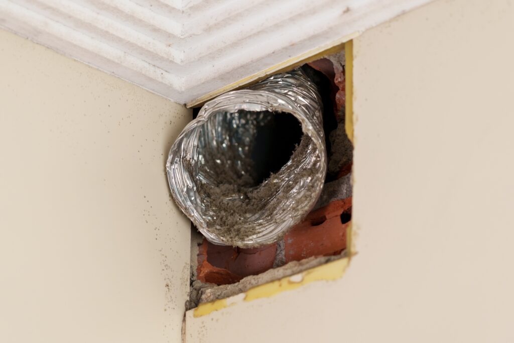 Technician inspecting residential duct system
