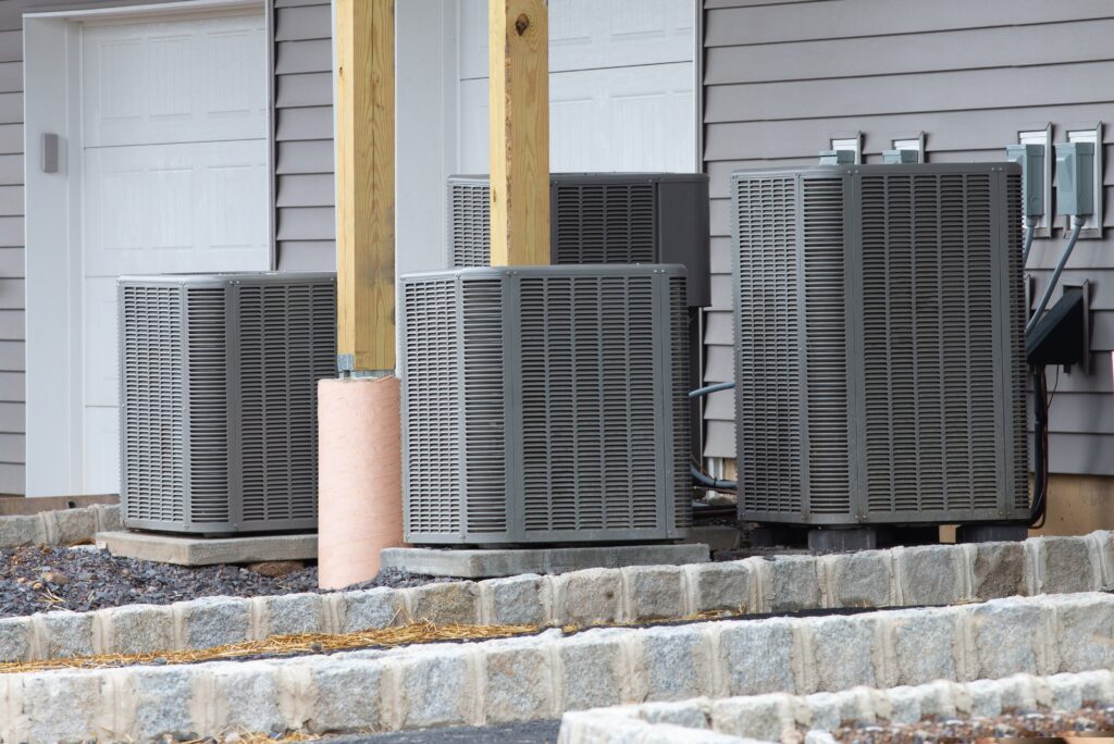 Technician connecting outdoor heat pump unit