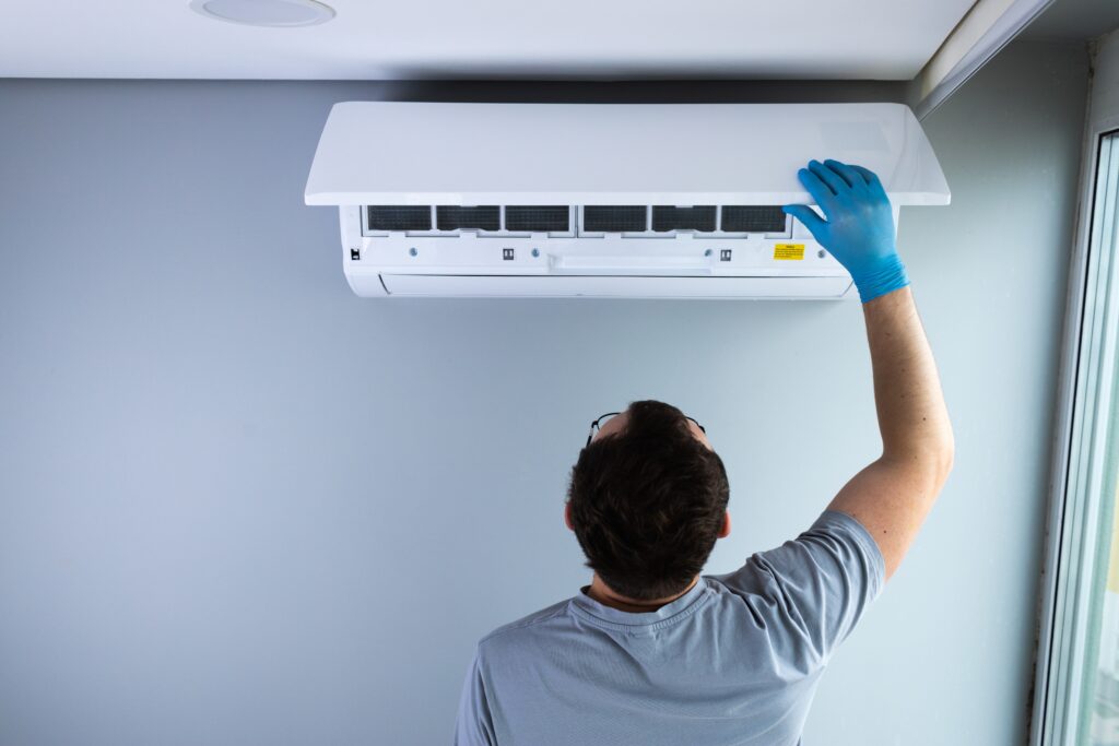 A technician checking an indoor air quality system.