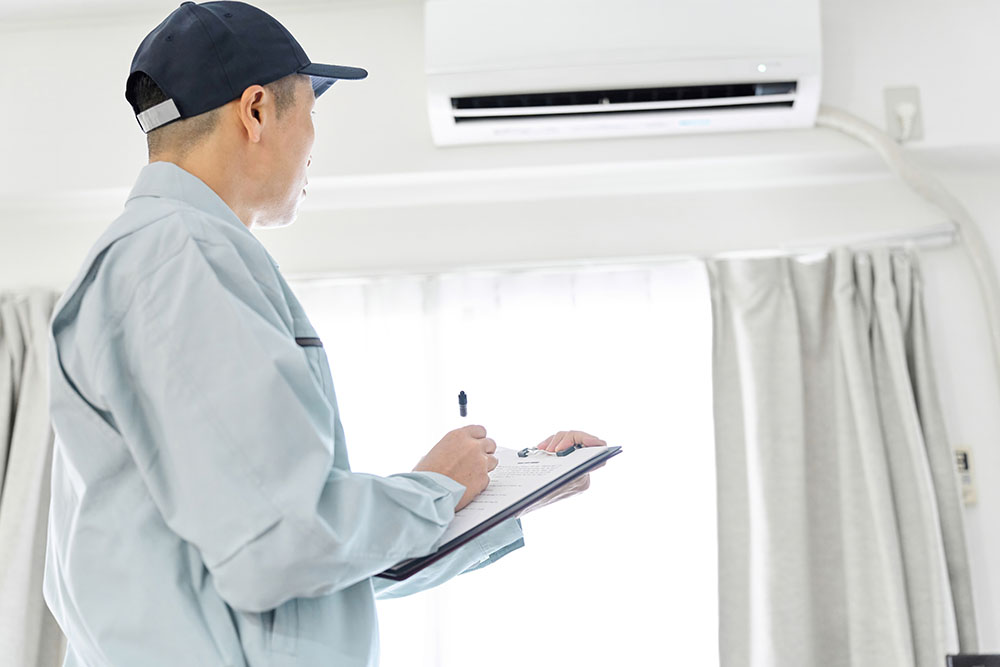 technician inspecting a home air conditioning unit