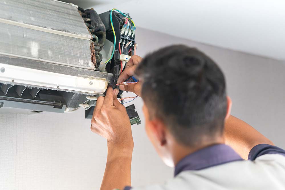 A technician repairing a home heating unit