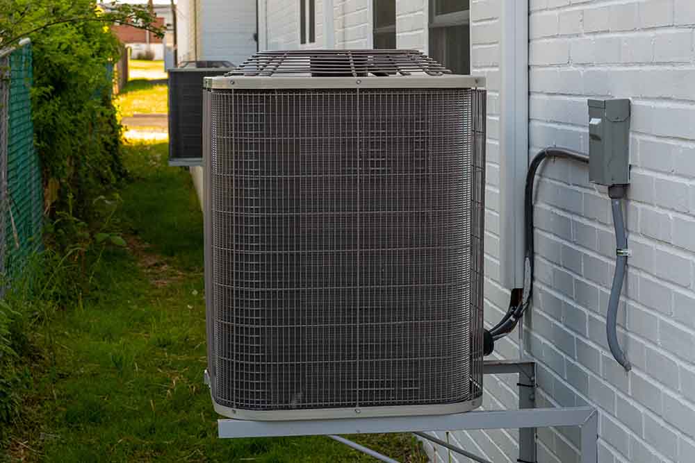 A contractor checking the HVAC system before replacement