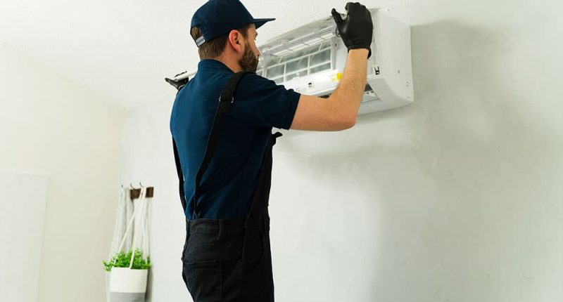 A sleek, modern central AC unit being installed by a professional technician.