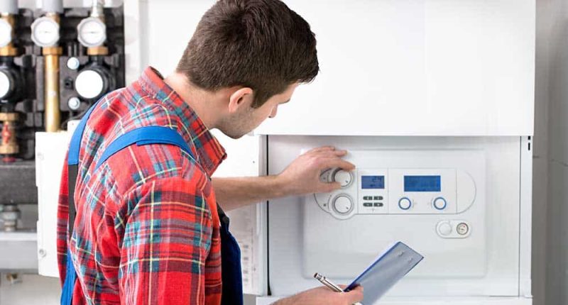 A technician showcasing a high-efficiency heating system.