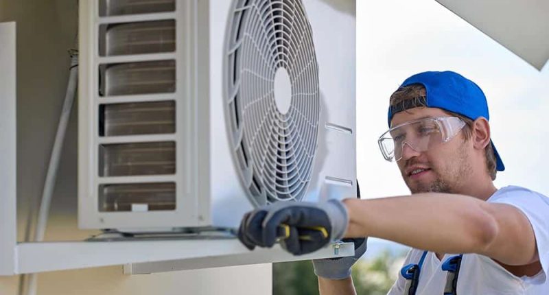 A technician performing maintenance on a modern HVAC system, with a focus on professionalism and quality tools.