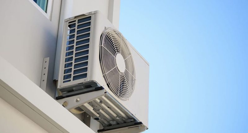 A split image showing one half of a home in hot, sunny weather and the other half in rainy, humid conditions. An HVAC unit is visible in both scenes, highlighting how the system works in changing climates.