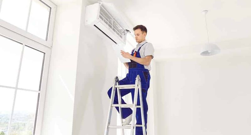 A technician installing a central AC unit in a modern home, showcasing expertise and attention to detail.