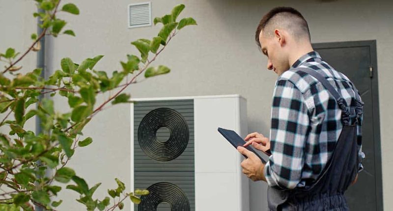 A technician from Plan B A/C inspecting or installing a heating unit.