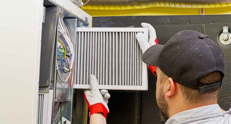 Technician Inspecting a Modern Heating System